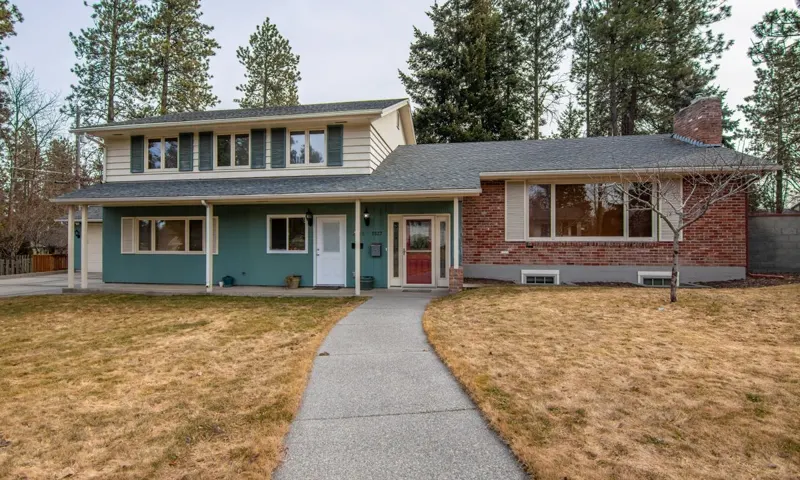 A front walkway leading to a house (illustrative stock photo)